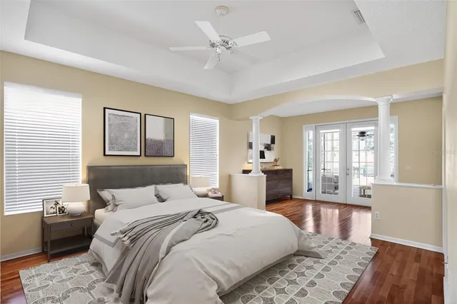 a kitchen with a refrigerator and a wooden floor