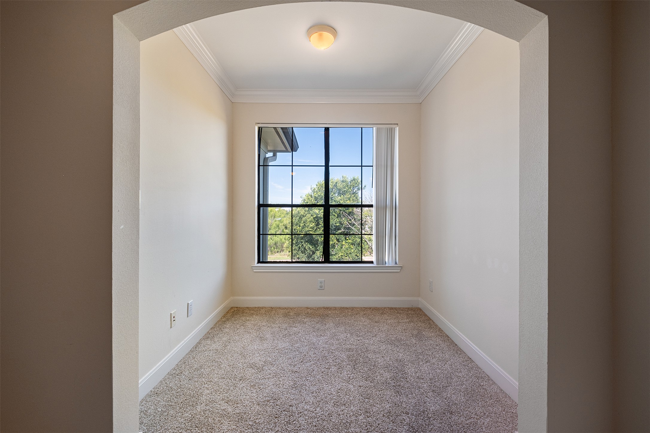 7701 Rialto Boulevard, Unit 637 Austin, TX 78735 - Photo 18 of 25 A quiet space for contemplation or work, featuring a broad window framing verdant outdoor views.
