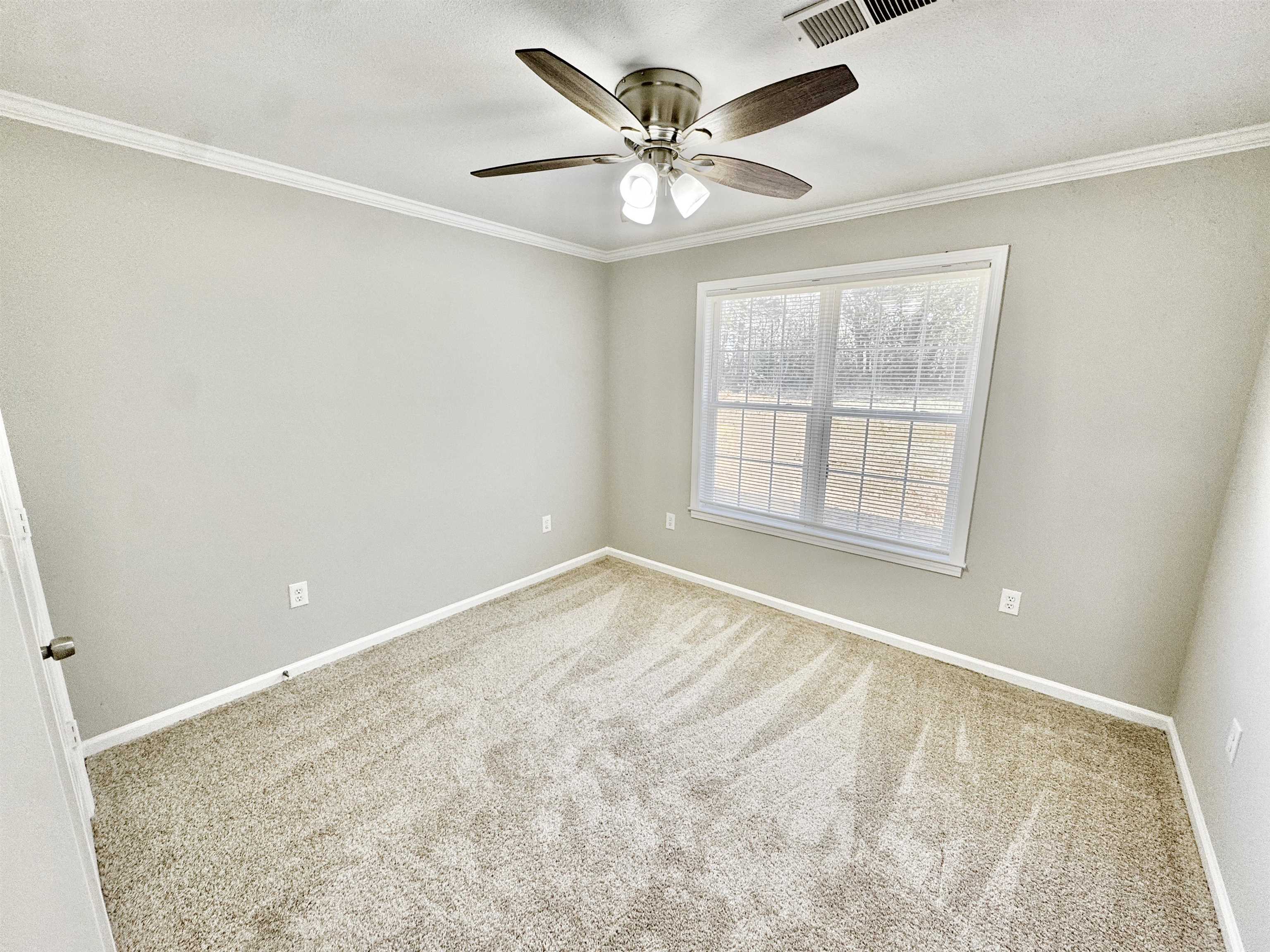 788 Bruce Road Whiteville, TN 38075 - Photo 14 of 39 Carpeted empty room featuring crown molding and ceiling fan