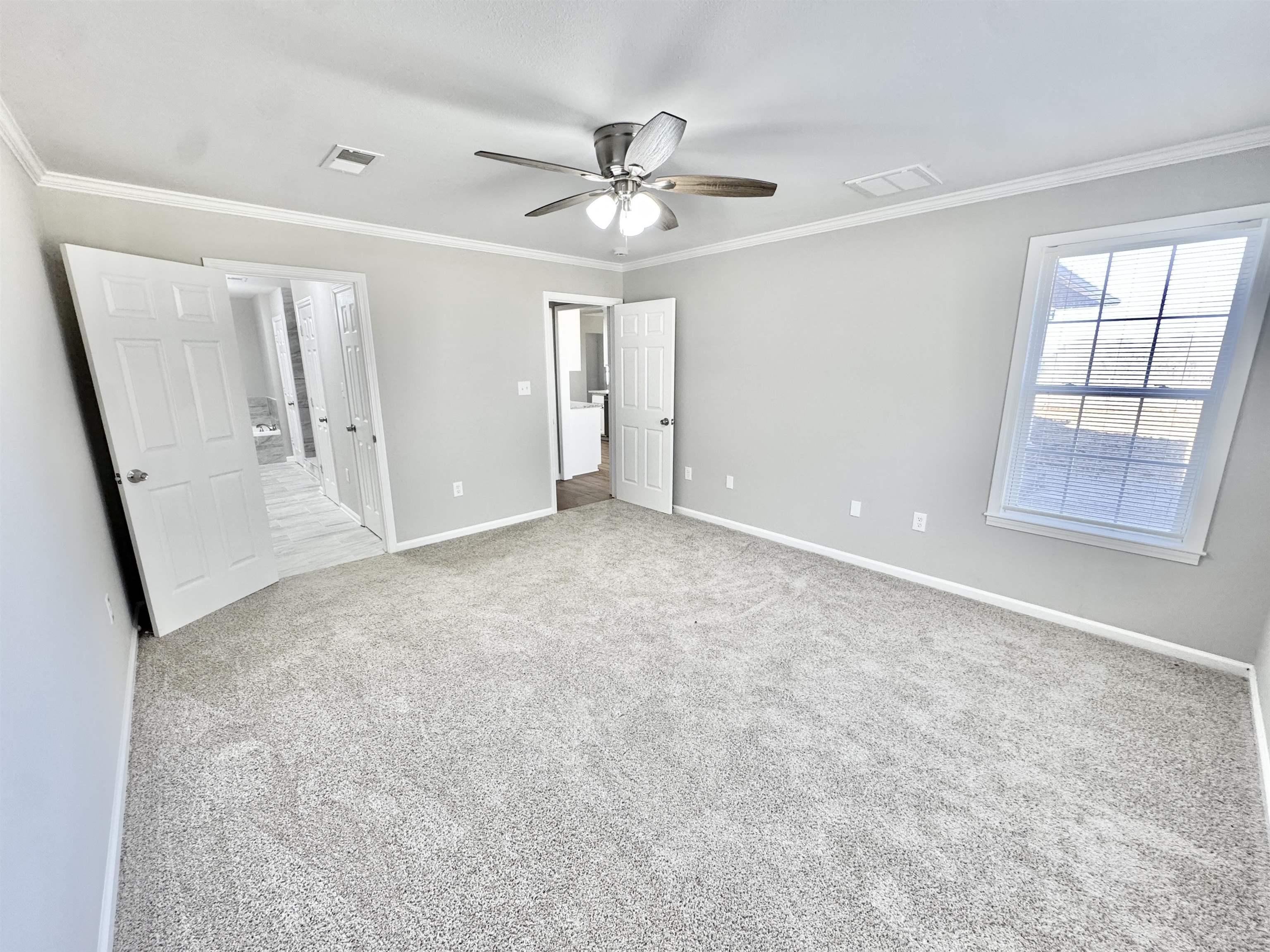 788 Bruce Road Whiteville, TN 38075 - Photo 20 of 39 Unfurnished bedroom with light carpet, ornamental molding, and a ceiling fan