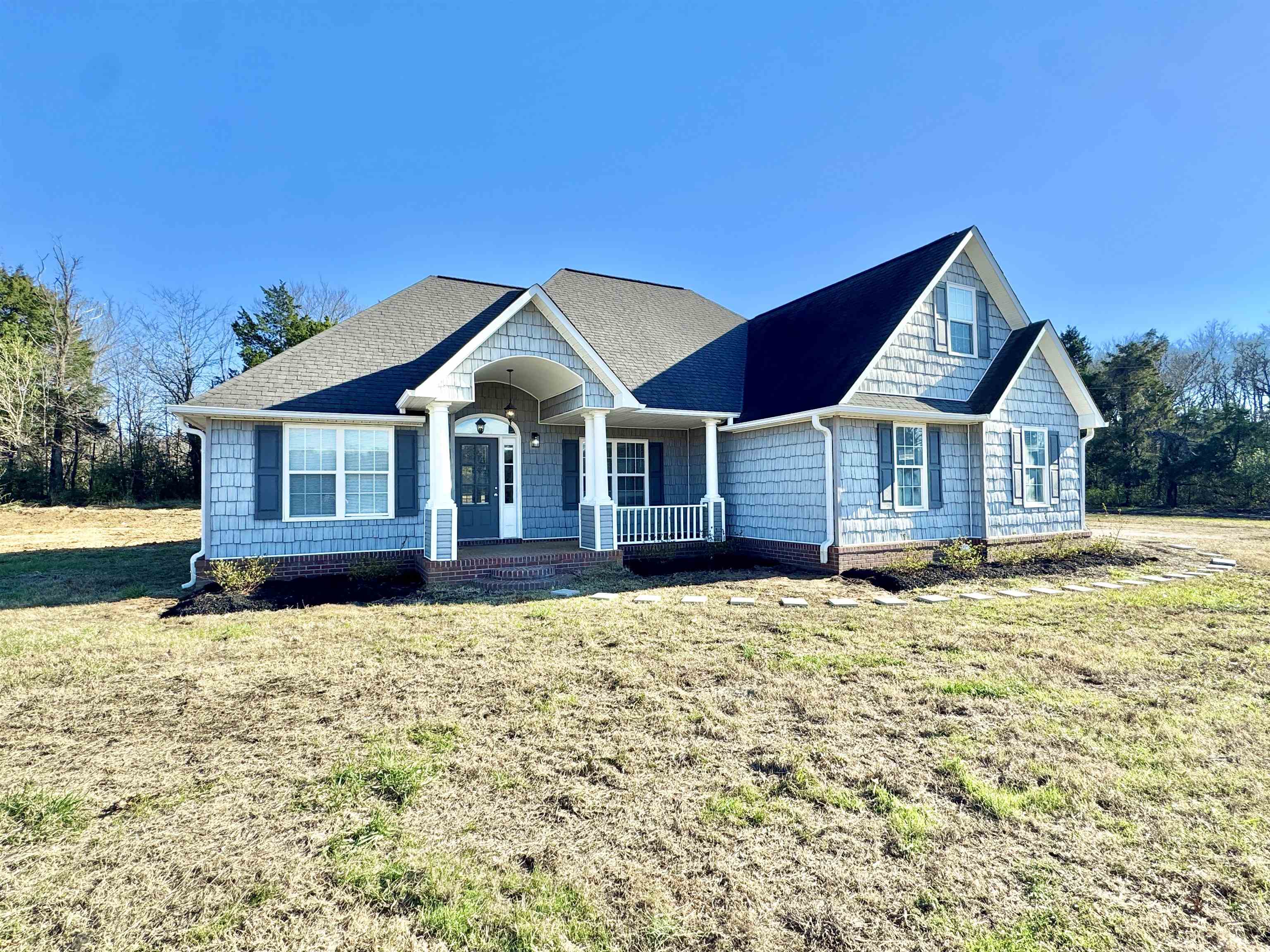 788 Bruce Road Whiteville, TN 38075 - Photo 36 of 39 View of front of house featuring covered porch, a front lawn, and roof with shingles