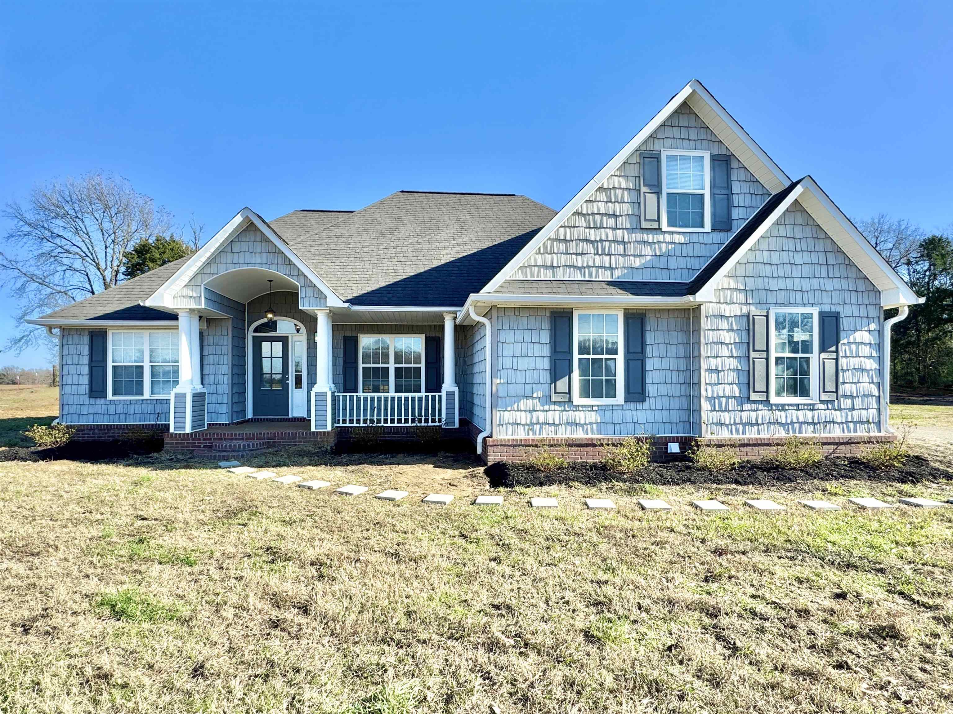 788 Bruce Road Whiteville, TN 38075 - Photo 37 of 39 View of front of house with a shingled roof, covered porch, a front yard, and crawl space
