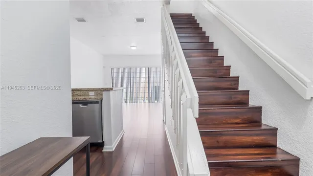 a view of entryway and hall with wooden floor