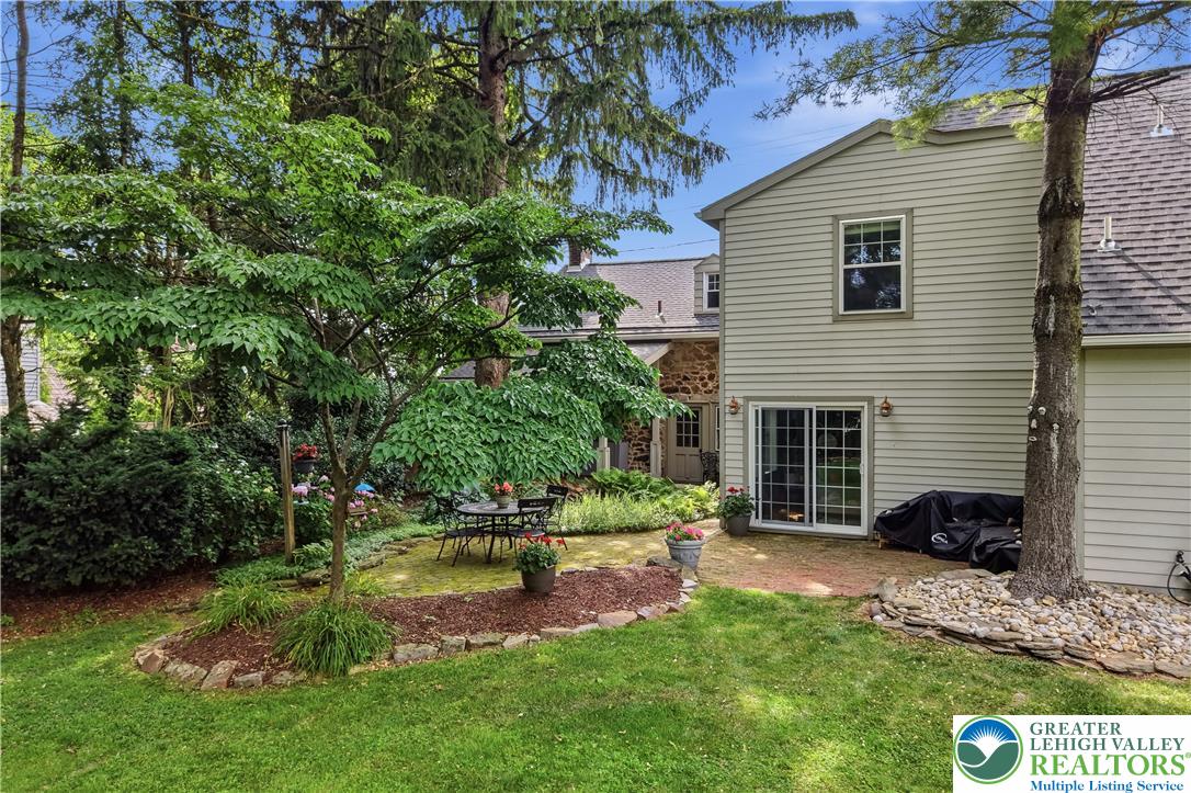 2014 Linden Street Bethlehem, PA 18017 - Photo 61 of 85 Enjoy outdoor dining on the brick patio, surrounded by lush green landscaping.