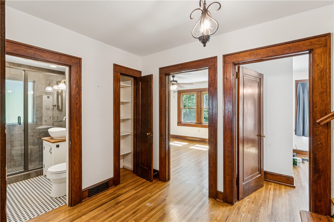 321 South Pine Street Walhalla, SC 29691 - Photo 10 of 32 Hardwood floors and rich wooden door frames create a traditional yet welcoming interior hallway.