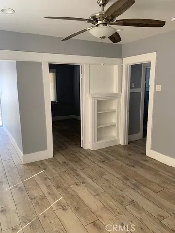 a view of an empty room with a ceiling fan