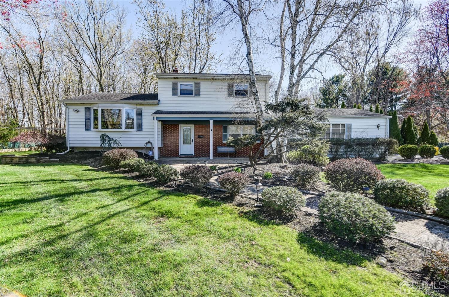 a front view of house with a garden
