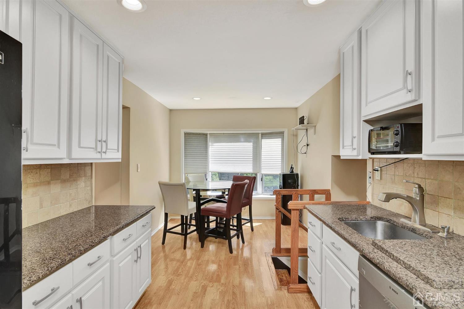 8 Innes Road East Brunswick, NJ 08816 - Photo 11 of 32 a kitchen with granite countertop a sink stove and cabinets