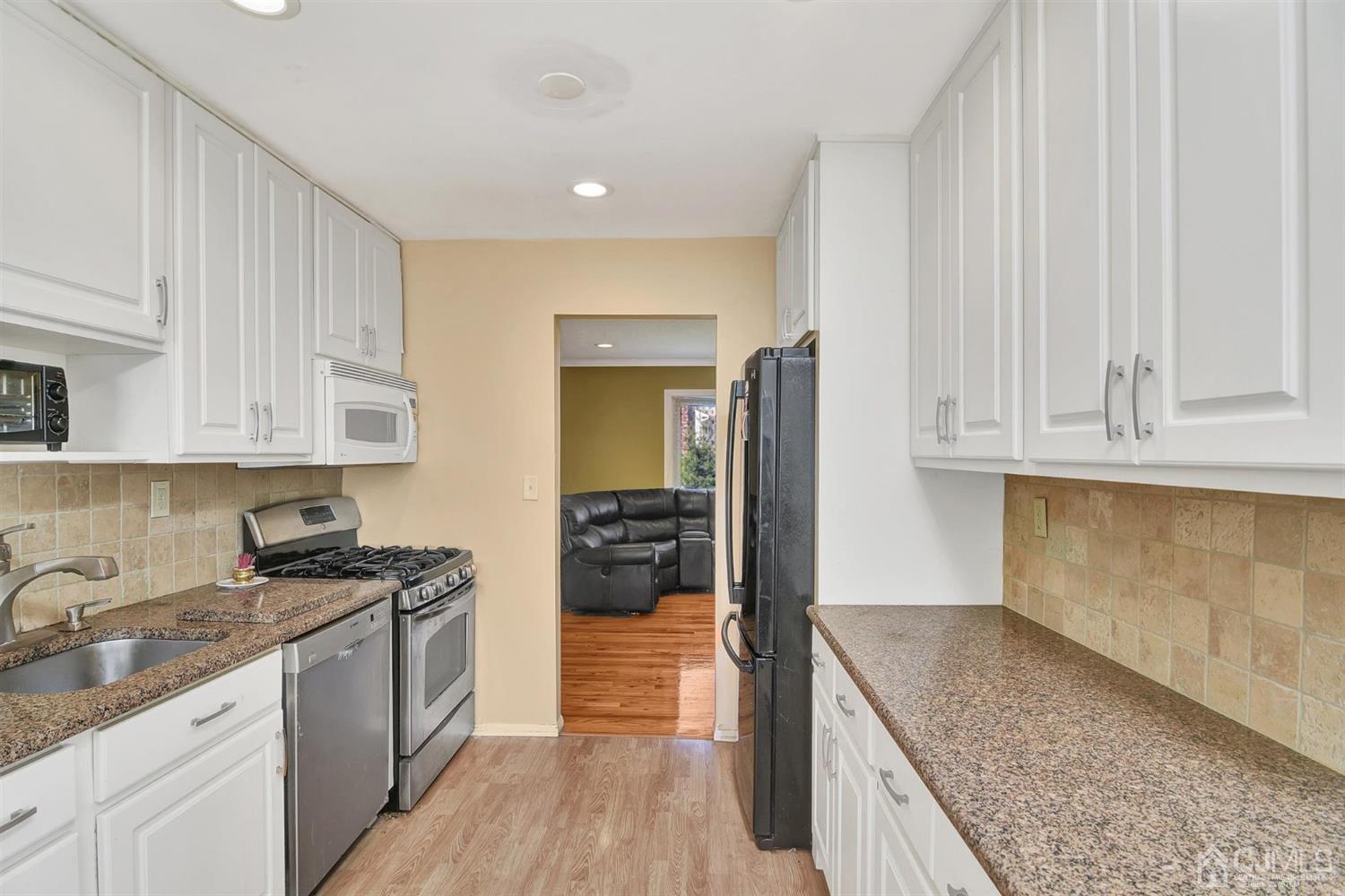 8 Innes Road East Brunswick, NJ 08816 - Photo 13 of 32 a kitchen with granite countertop a sink stainless steel appliances and cabinets