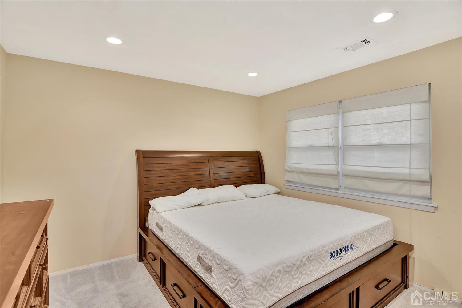 8 Innes Road East Brunswick, NJ 08816 - Photo 14 of 32 a bedroom with a bed and window