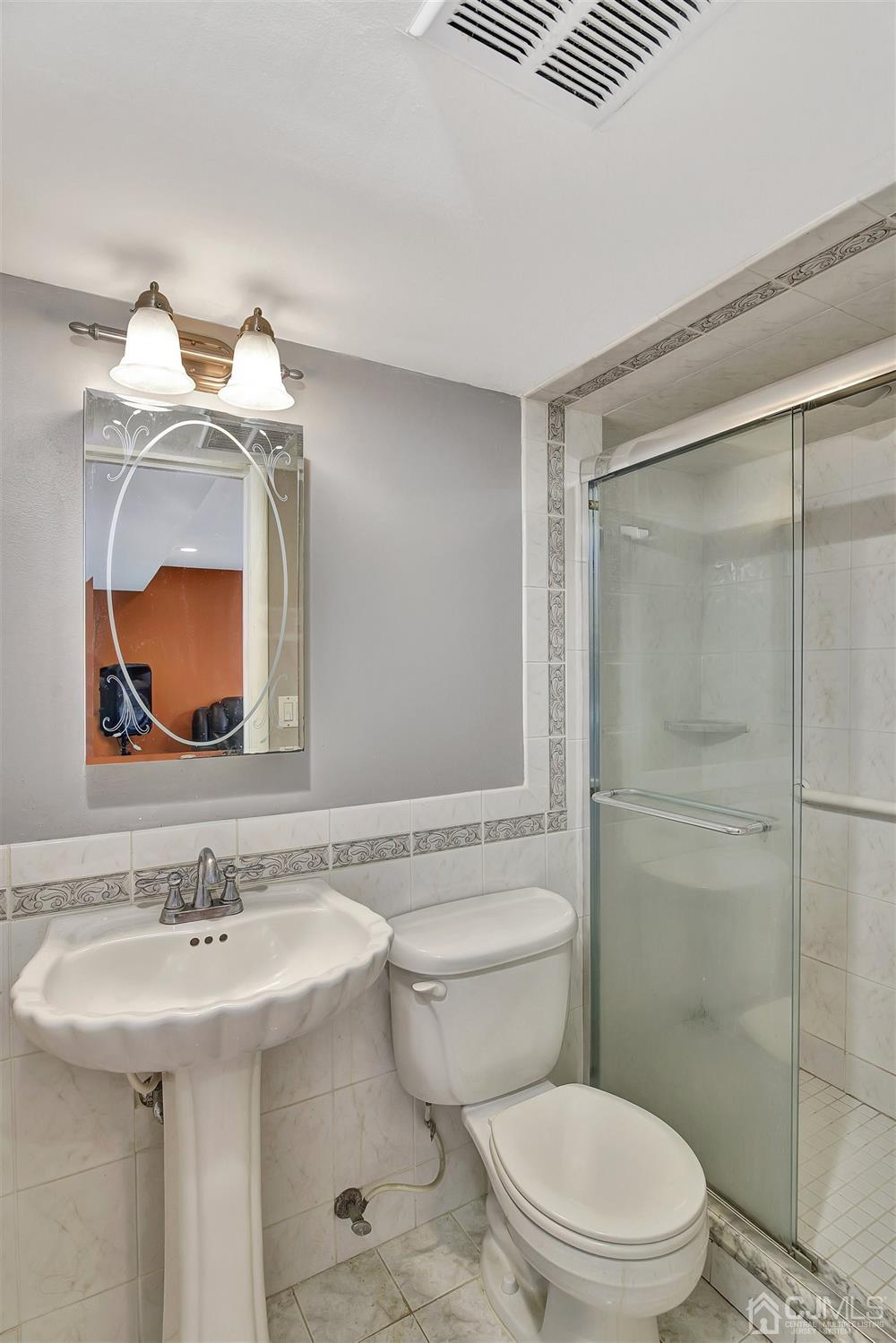 8 Innes Road East Brunswick, NJ 08816 - Photo 15 of 32 a bathroom with a sink toilet and shower