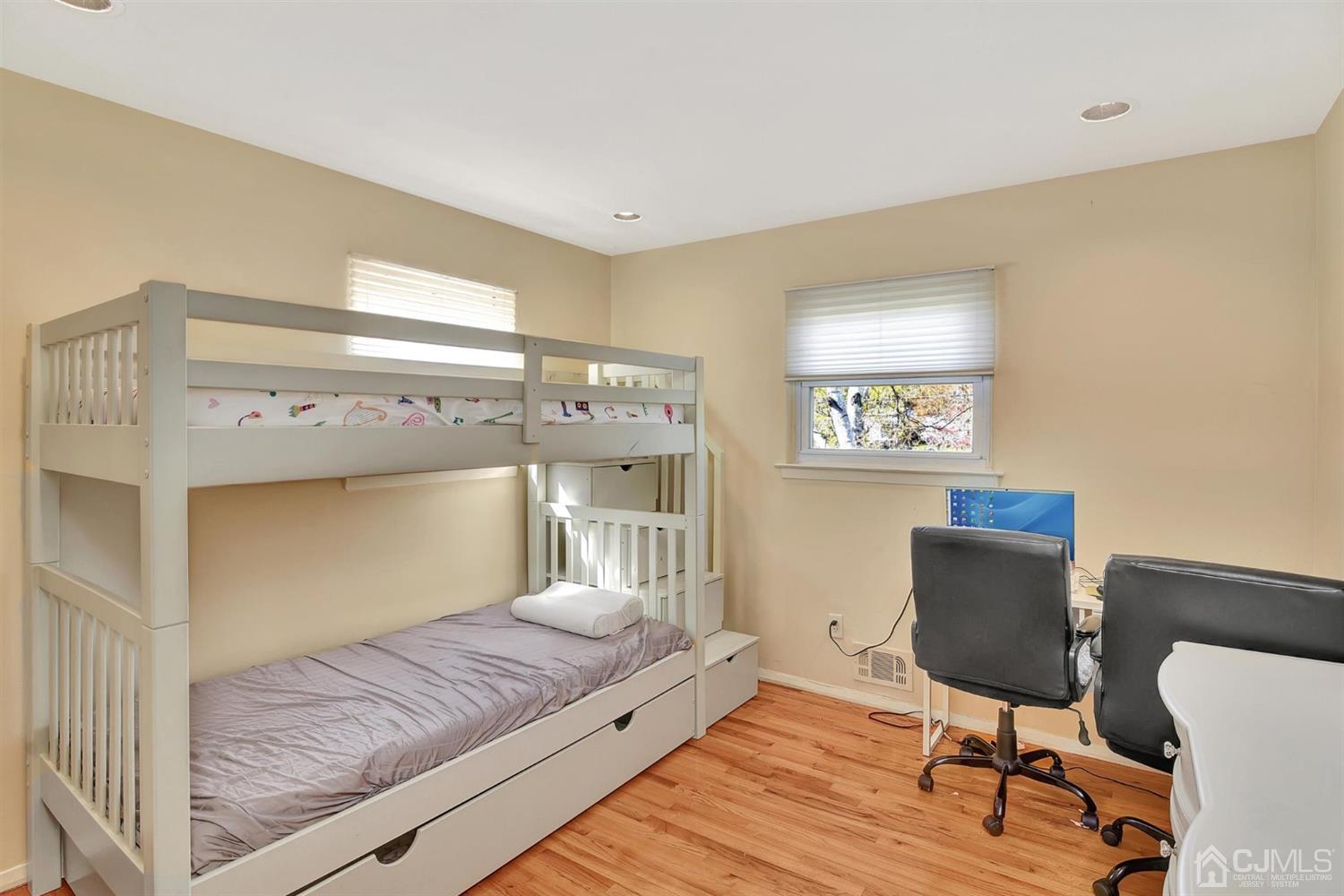 8 Innes Road East Brunswick, NJ 08816 - Photo 22 of 32 a bedroom with a bed and wooden floor