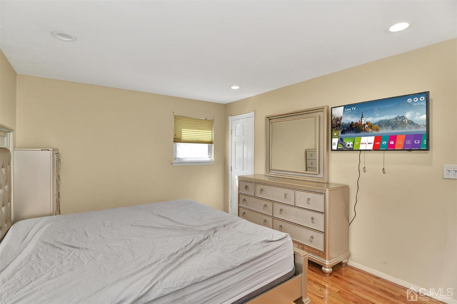 8 Innes Road East Brunswick, NJ 08816 - Photo 25 of 32 a bedroom with a bed and a flat screen tv