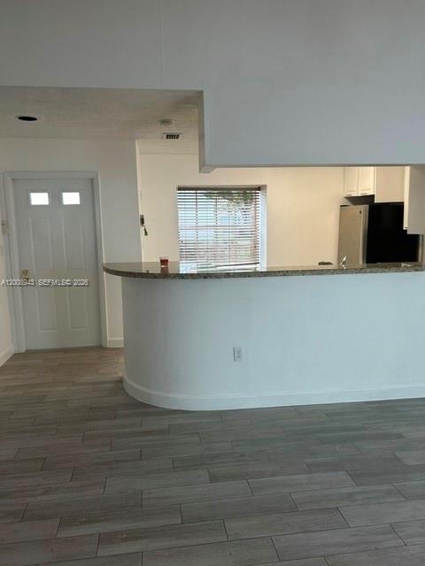 a view of kitchen cabinets and wooden floor