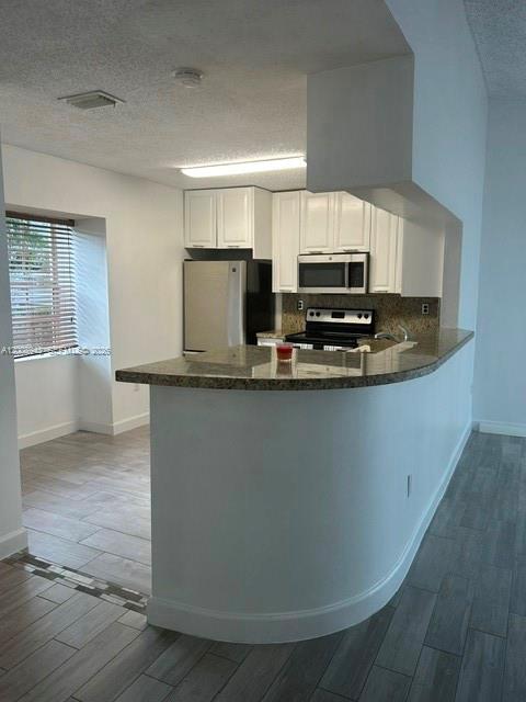 13716 Southwest 149th Cir Lane, Unit 461 Miami, FL 33186 - Photo 2 of 9 a kitchen with kitchen island stainless steel appliances a sink and a stove