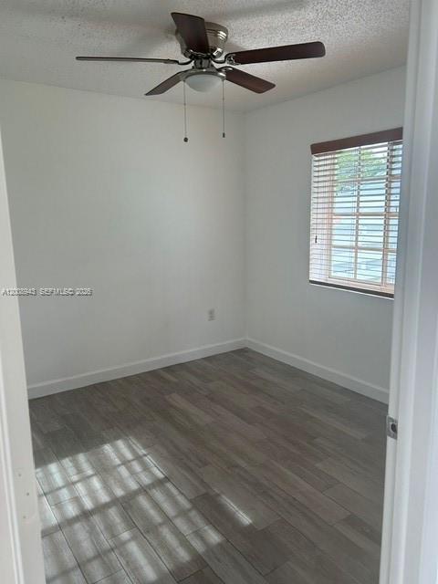 13716 Southwest 149th Cir Lane, Unit 461 Miami, FL 33186 - Photo 5 of 9 an empty room with wooden floor and windows