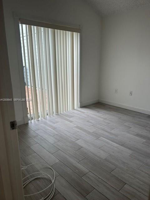 13716 Southwest 149th Cir Lane, Unit 461 Miami, FL 33186 - Photo 8 of 9 a view of a room with wooden floor and furniture