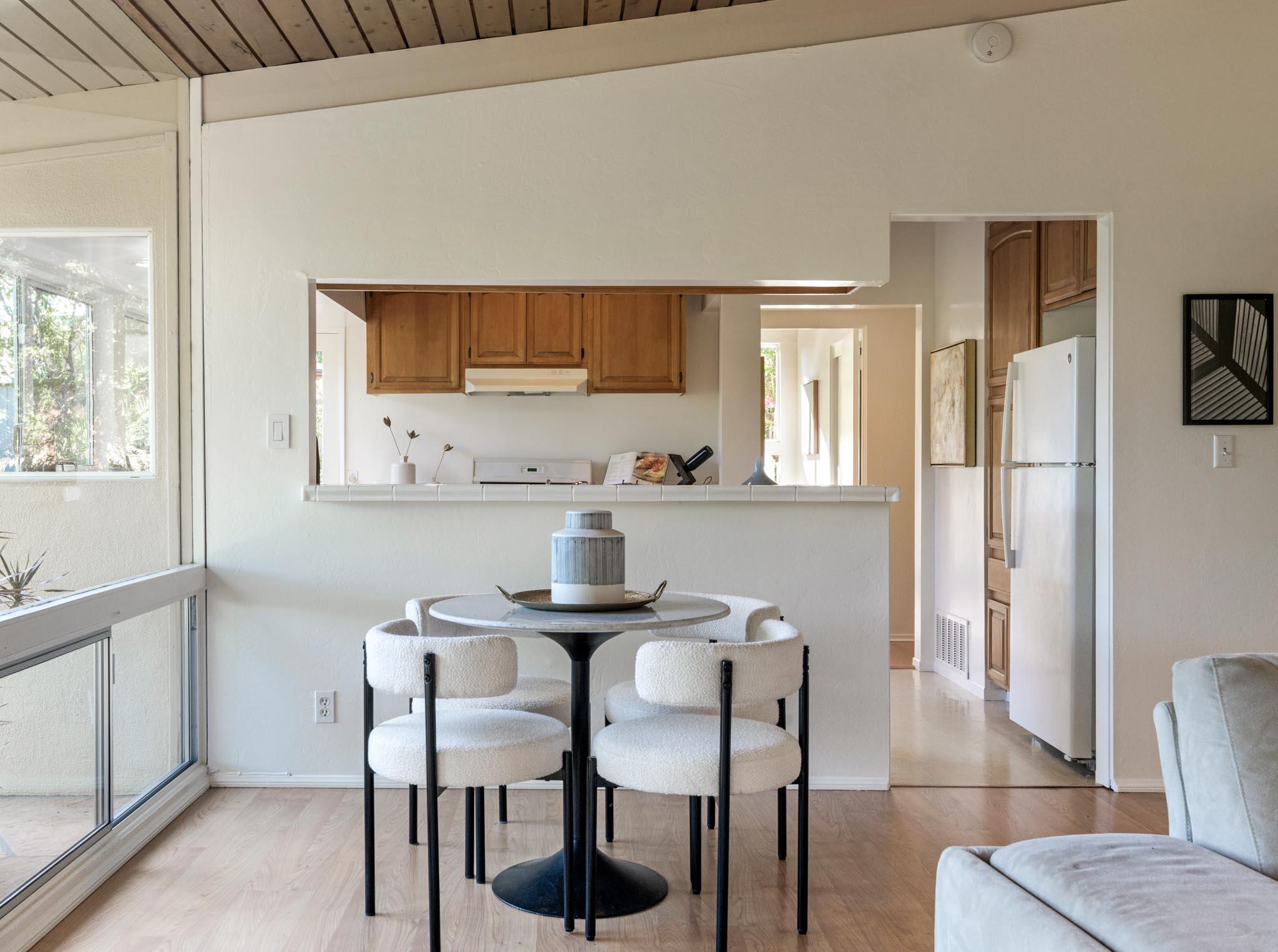 4840 Winding Way Santa Barbara, CA 93111 - Photo 8 of 22 a kitchen with stainless steel appliances a table chairs and a refrigerator