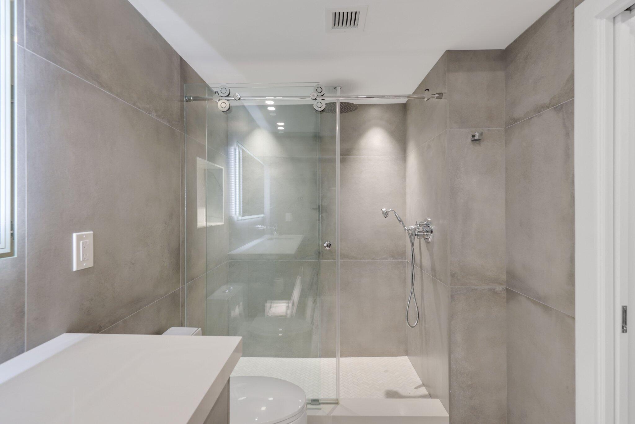 100 Southeast 5th Avenue, Unit 106 Boca Raton, FL 33432 - Photo 37 of 81 a bathroom with a shower and a toilet