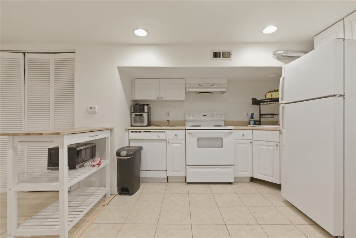 3716 North Wayne Avenue, Unit GR Chicago, IL 60613 - Photo 2 of 10 a kitchen with white cabinets and white appliances
