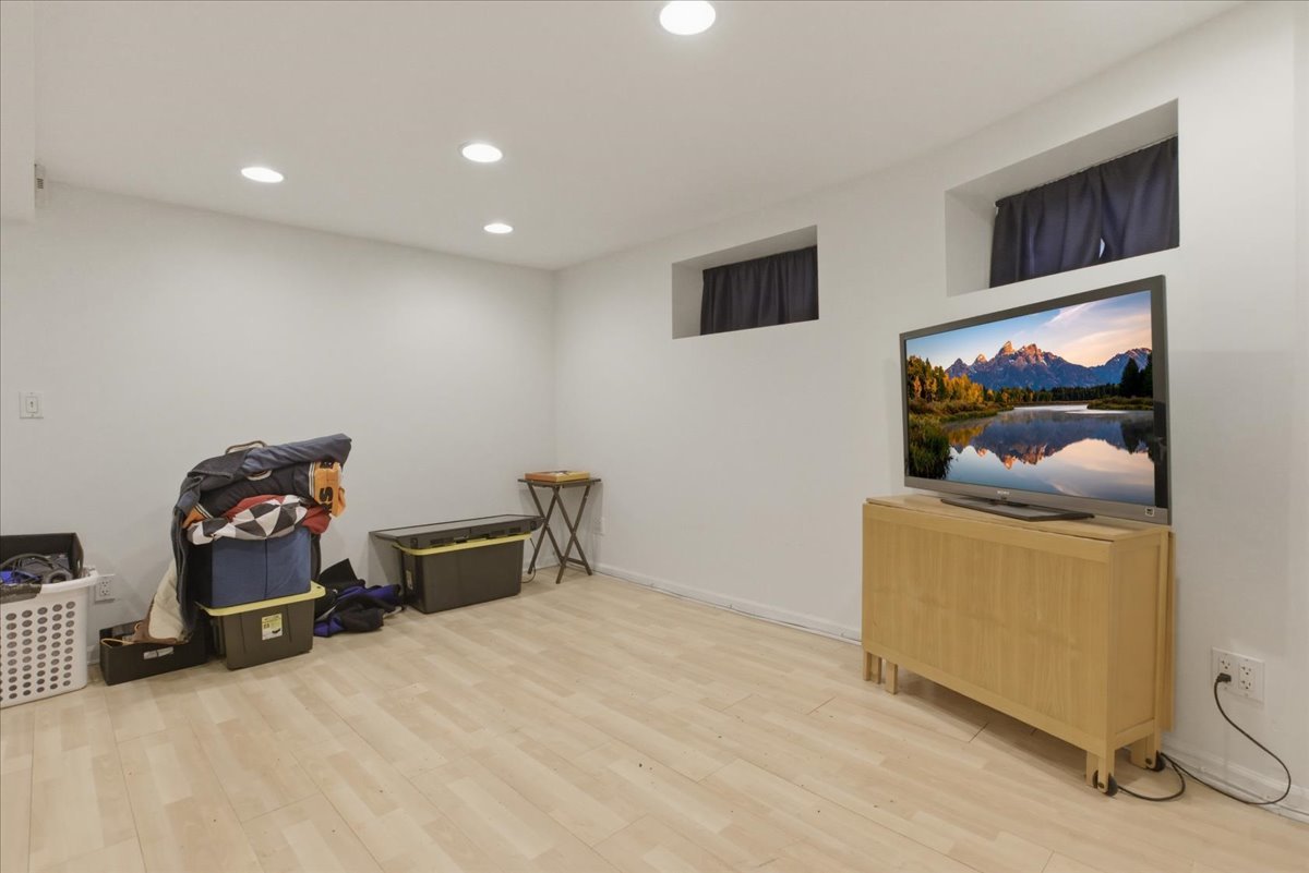 3716 North Wayne Avenue, Unit GR Chicago, IL 60613 - Photo 3 of 10 a bed room with furniture and a flat screen tv