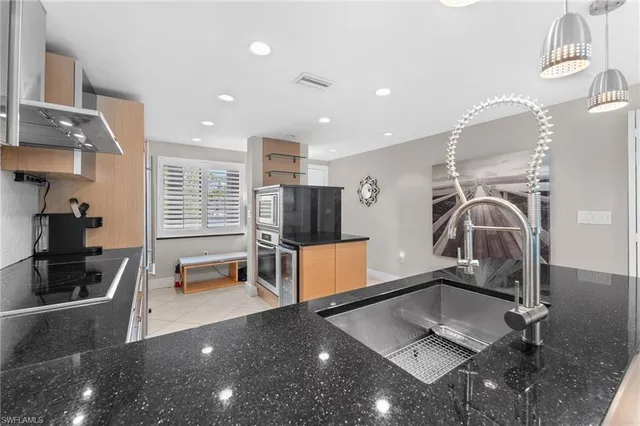 a kitchen with a sink and a stove top oven