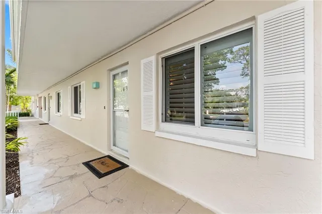 a front view of a multi story building with yard