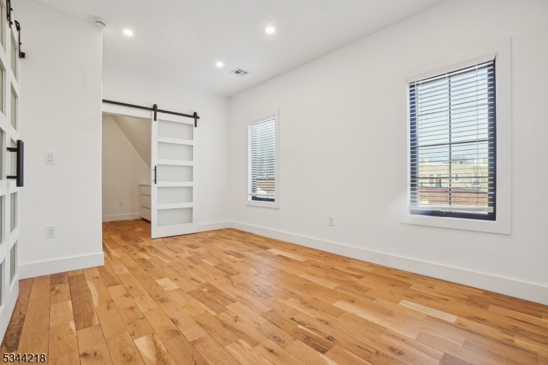 51 New Street, Unit B Montclair, NJ 07042 - Photo 11 of 32 an empty room with windows and closet