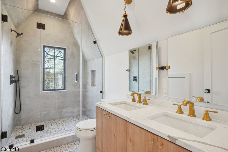 51 New Street, Unit B Montclair, NJ 07042 - Photo 15 of 32 a bathroom with a granite countertop sink a toilet and shower