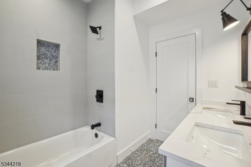 51 New Street, Unit B Montclair, NJ 07042 - Photo 16 of 32 a bathroom with a tub sink and mirror