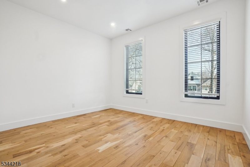 51 New Street, Unit B Montclair, NJ 07042 - Photo 19 of 32 an empty room with wooden floor and windows