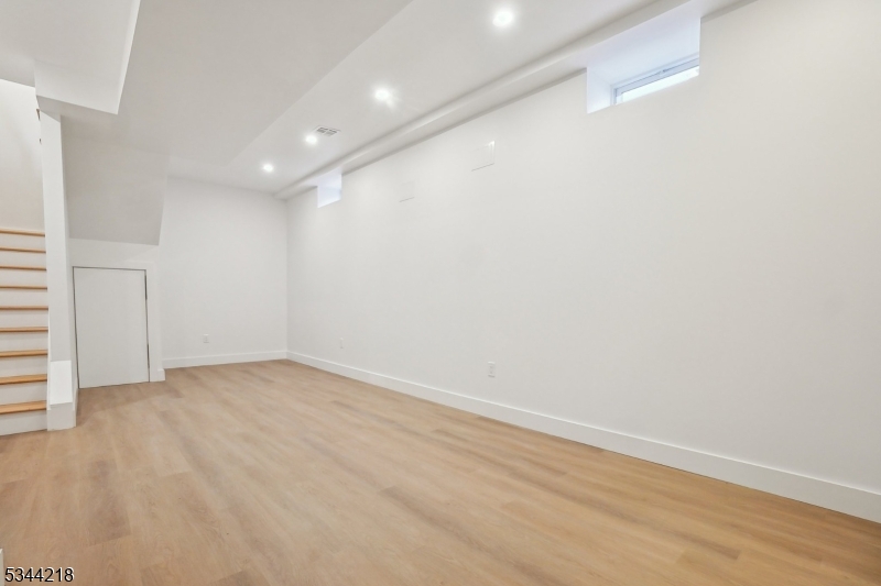 51 New Street, Unit B Montclair, NJ 07042 - Photo 24 of 32 an empty room with wooden floor and white walls