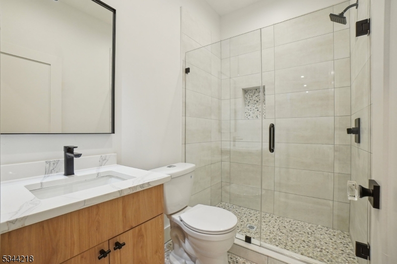 51 New Street, Unit B Montclair, NJ 07042 - Photo 25 of 32 a bathroom with a sink toilet and shower