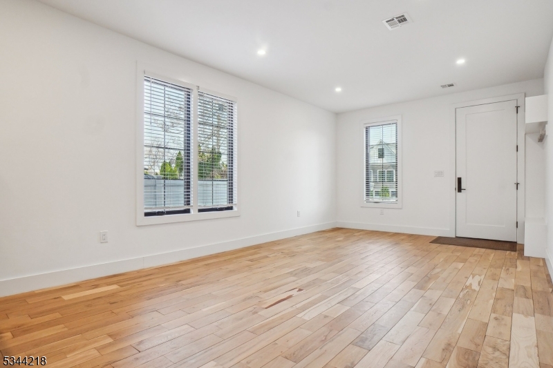 51 New Street, Unit B Montclair, NJ 07042 - Photo 4 of 32 a view of an empty room with wooden floor and a window