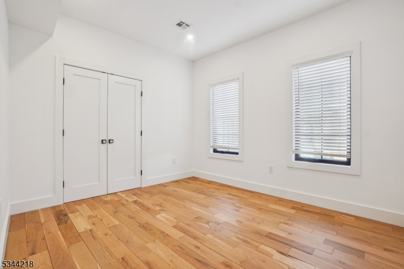 51 New Street, Unit B Montclair, NJ 07042 - Photo 8 of 32 a view of empty room with wooden floor and fan