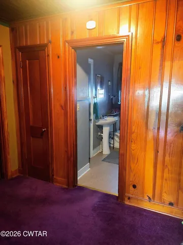 a view of a elevator with an empty room and wooden floor