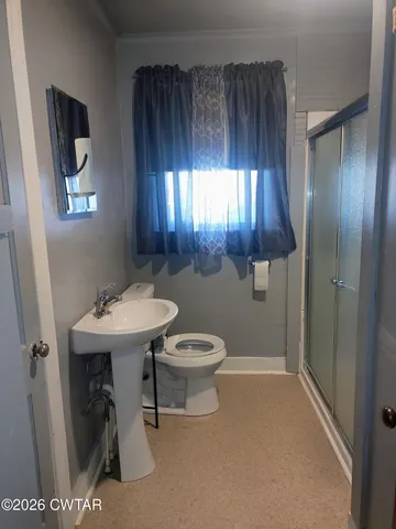 a bathroom with a sink a toilet and mirror