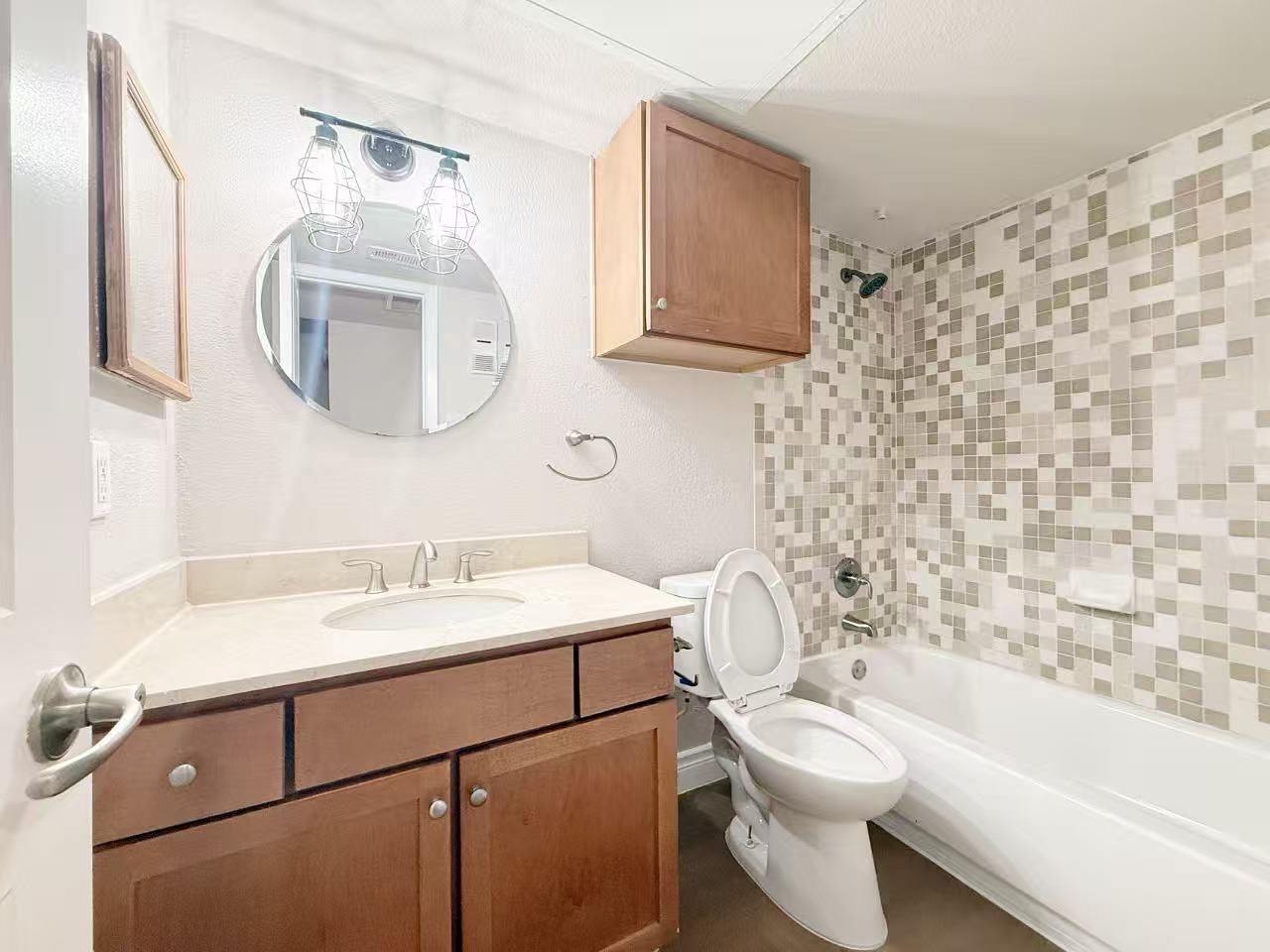 3204 Menchaca Road, Unit 601 Austin, TX 78704 - Photo 6 of 12 a bathroom with a sink a toilet and a mirror