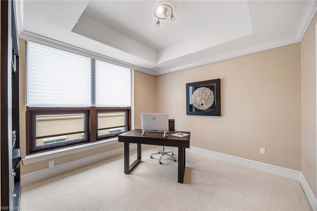 9115 Strada Place, Unit 5416 Naples, FL 34108 - Photo 18 of 44 Office area with a tray ceiling and carpet flooring