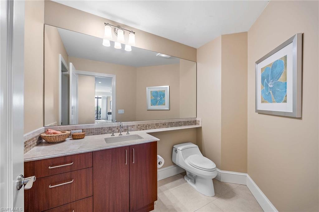 9115 Strada Place, Unit 5416 Naples, FL 34108 - Photo 20 of 44 Half bathroom with vanity and light tile patterned flooring