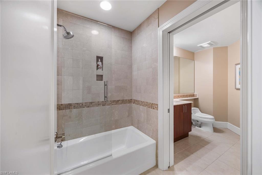 9115 Strada Place, Unit 5416 Naples, FL 34108 - Photo 21 of 44 Full bath with vanity, light tile patterned floors, and shower / bath combination