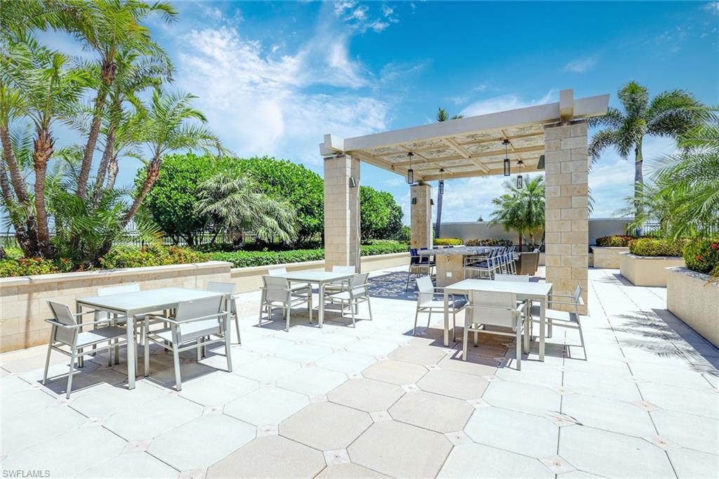 9115 Strada Place, Unit 5416 Naples, FL 34108 - Photo 38 of 44 View of patio / terrace featuring outdoor dining space and a pergola