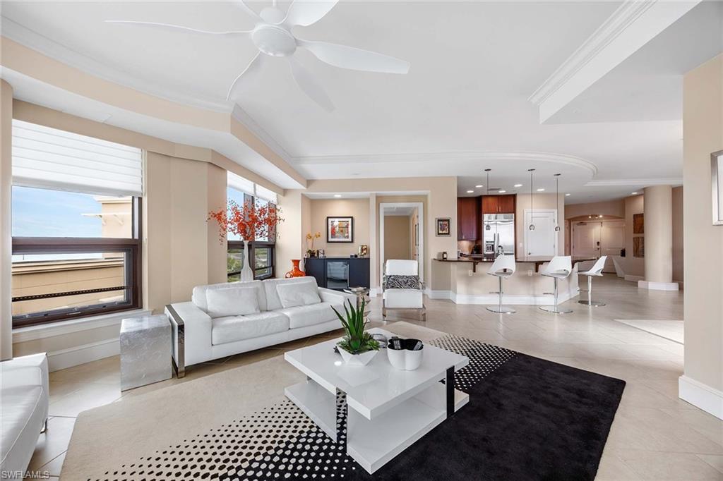 9115 Strada Place, Unit 5416 Naples, FL 34108 - Photo 9 of 44 Living area featuring crown molding, light tile patterned floors, and a ceiling fan