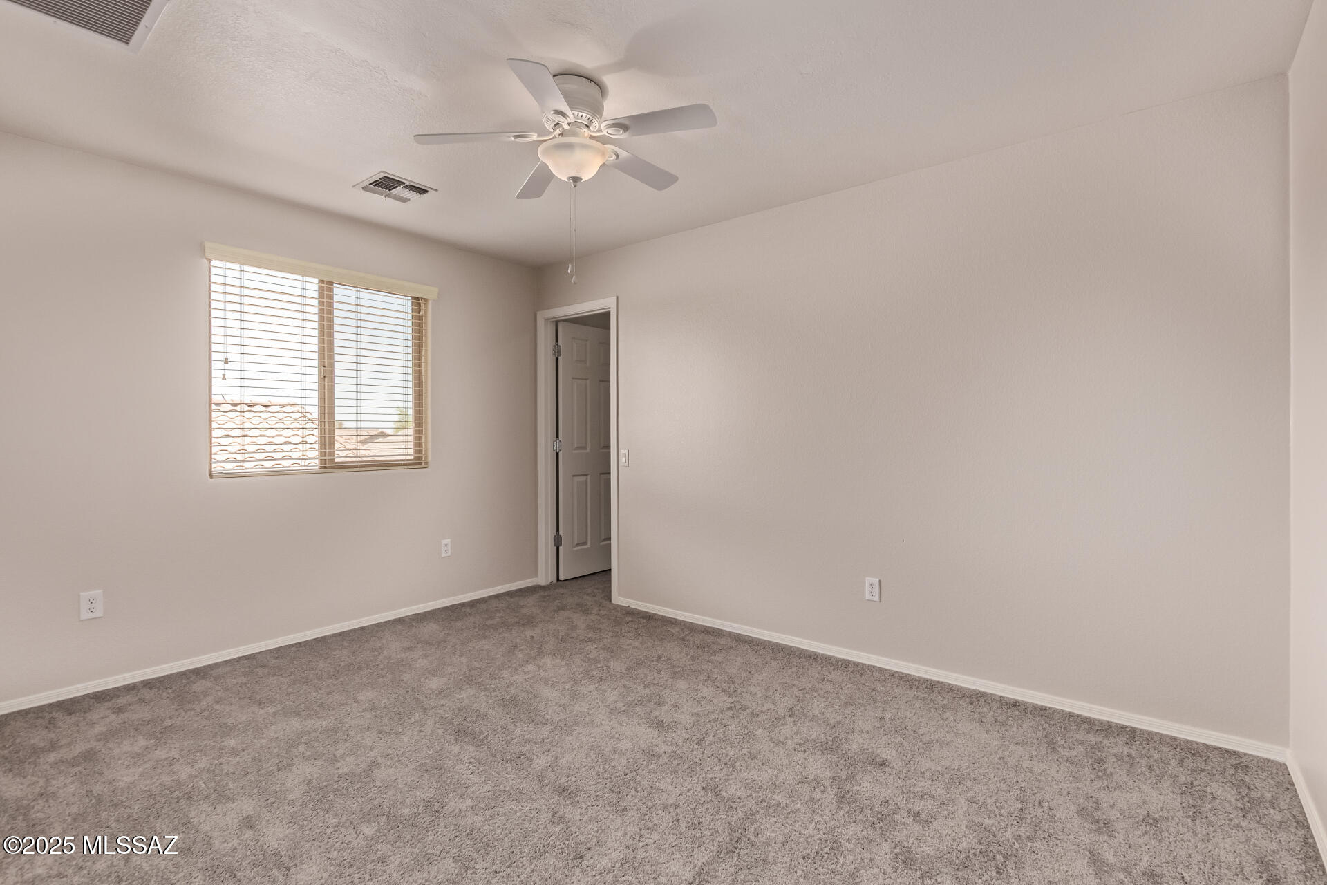 20950 East Frontier Road Red Rock, AZ 85145 - Photo 27 of 44 an empty room with windows and fan