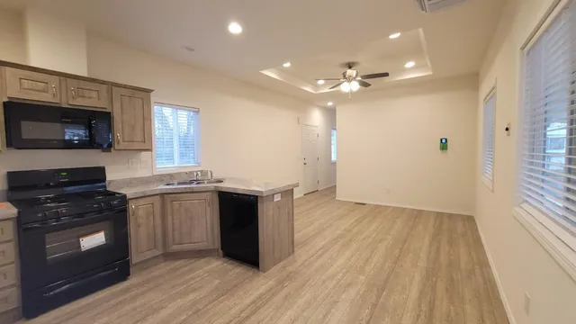 a kitchen with a stove a sink and a refrigerator