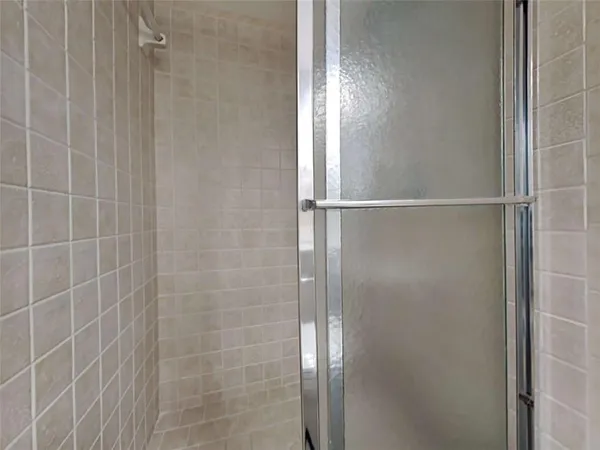 a bathroom with a glass shower door