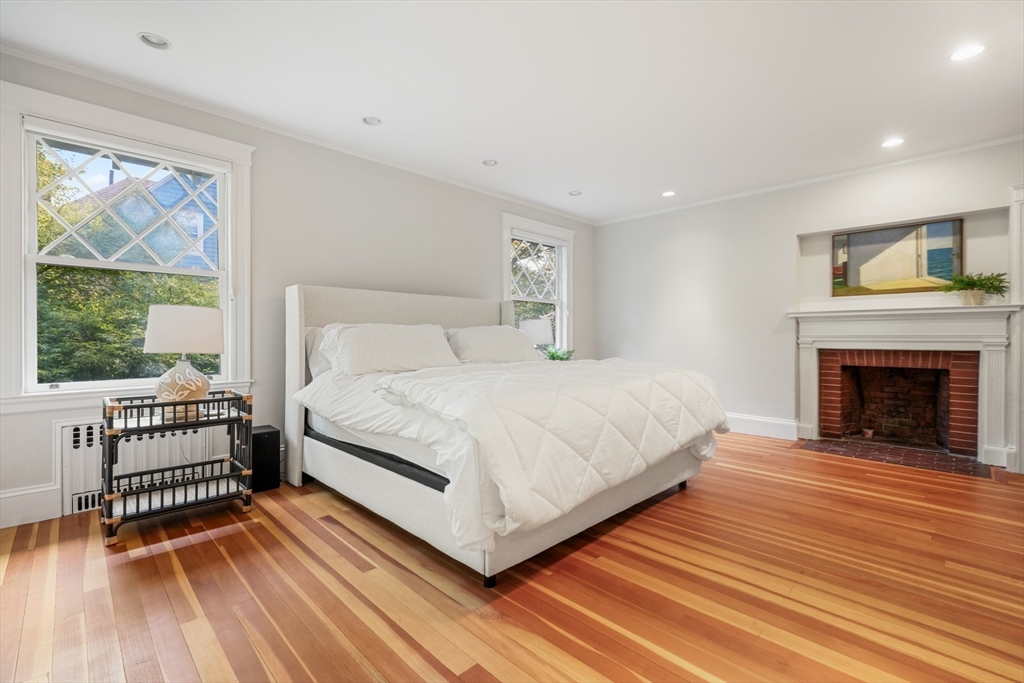 85 Williston Road Brookline, MA 02445 - Photo 13 of 29 a bedroom with a bed and a fireplace