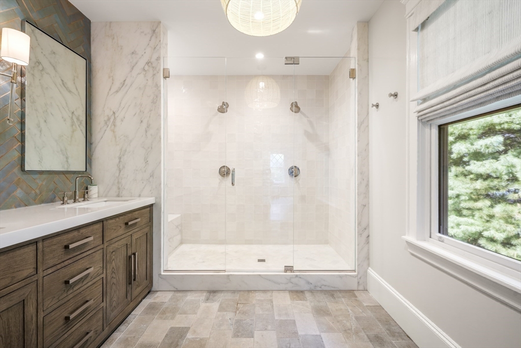 85 Williston Road Brookline, MA 02445 - Photo 14 of 29 a bathroom with a granite countertop sink a toilet and shower