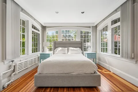 a large bedroom with a bed and glass window