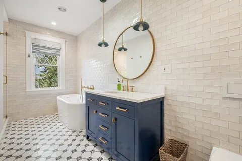 a bathroom with a double vanity sink mirror and toilet